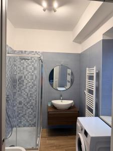 a bathroom with a sink and a shower with a mirror at Al vico1 in Campo Calabro +17 photos