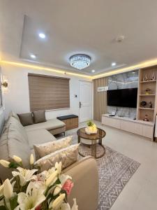a living room with a couch and a table at CJ Premier Stays at Amalfi Oasis Near SM Seaside Mall & Nustar Casino Hotel, Cebu City in Cebu City