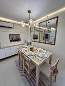 a dining room with a table with chairs and a mirror at CJ Premier Stays at Amalfi Oasis Near SM Seaside Mall & Nustar Casino Hotel, Cebu City in Cebu City