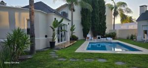 a house with a swimming pool in the yard at Blue House in San Pedro