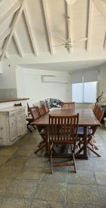 a dining room with a wooden table and chairs at Blue House in San Pedro +11 photos