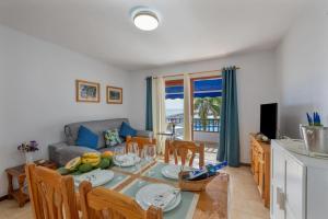 a dining room and living room with a table and chairs at Lago Azul 59 SEA VIEW LOS CANCAJOS in Los Cancajos