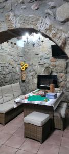 a room with a bed and a stone wall at Cal Belló in Hostafranco