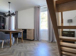 a living room with a table and a window at Le cocon d Épinal in Épinal