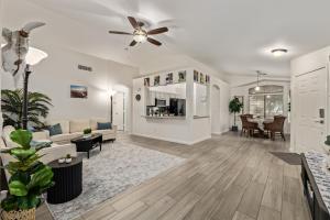 a living room with a couch and a ceiling fan at West Valley Pool Side Oasis in Surprise