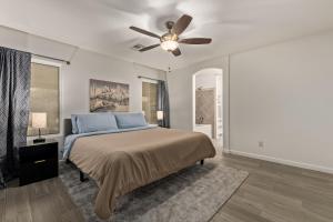 a bedroom with a bed and a ceiling fan at West Valley Pool Side Oasis in Surprise +19 photos
