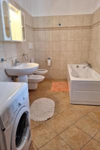 a bathroom with a washer and dryer in it at Apartment Manna Hof by Interhome in Irgoli