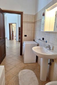 a bathroom with a sink and a toilet and a sink at Apartment Manna Hof by Interhome in Irgoli