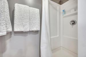 a bathroom with white towels hanging on a door at 127 Hwy 71 AT Bunk House in Arnolds Park