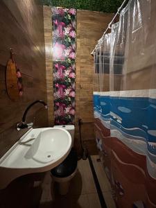 a bathroom with a sink and a toilet and a shower at Apartamento Reserva Sapiranga in Praia do Forte +11 photos