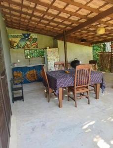 a dining table and chairs on a patio at Relax Private Room - Santo André, BA in Santo André
