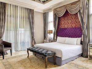 a bedroom with a king sized bed with a purple headboard at Mövenpick Resort Khao Yai in Ban Wang Sai