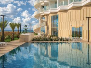 a hotel with a swimming pool in front of a building at STORY Le Carrousel Rabat in Rabat