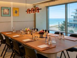 a conference room with a long table and a large window at STORY Le Carrousel Rabat in Rabat