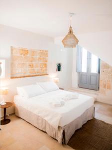 a bedroom with a large white bed in a room at Profumo Antico - Luxury Guesthouse by STHEY in Monopoli