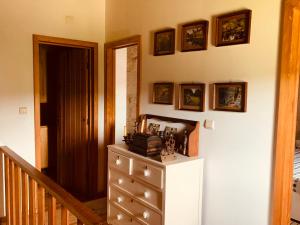 a room with a dresser and some pictures on the wall at Refúgio da Póvoa Dão in Silgueiros