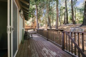 a wooden porch with a bench on the side of a house at Peaceful Mountain Sanctuary near Arrowhead Village in Lake Arrowhead