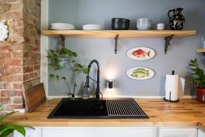 a kitchen with a sink and a counter top at Couples Cottage with Hot Tub in Mathews +14 photos