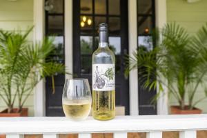 a bottle of wine sitting next to a wine glass at Couples Cottage with Hot Tub in Mathews