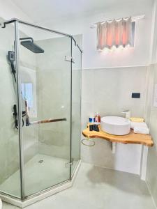 a bathroom with a glass shower and a sink at VENICE by luxury Atitlan in San Pedro La Laguna +24 photos