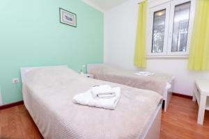 a room with two beds and two windows at House Ratac in Bol +31 photos