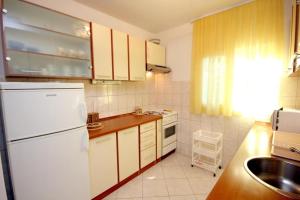 a kitchen with white appliances and a white refrigerator at House Paulo3 in Rogačić +16 photos