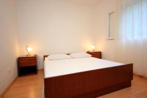 a bedroom with a bed and two lamps on night stands at House Paulo3 in Rogačić