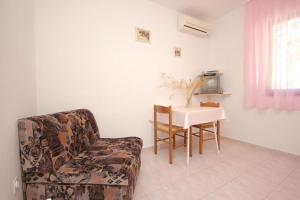 a living room with a chair and a table at House Paulo1 in Rogačić