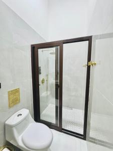 a bathroom with a white toilet and a shower at NEW YORK by luxury atitlan in San Pedro La Laguna +38 photos
