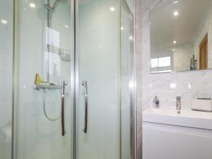 a bathroom with a shower and a sink at Riverside Cottage in Warkworth +32 photos