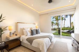 a bedroom with a bed and a large window at Exclusive Oceanfront Apartment Beach access in Acapulco +96 photos