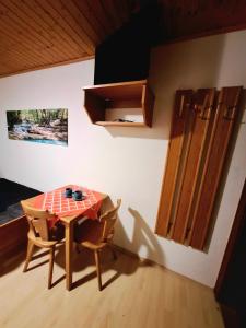 a table and two chairs in a room with a kitchen at Pension Haus Marianne in Bad Vöslau