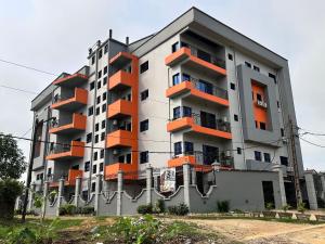 an apartment building with orange balconies on it at Résidence Prestige KGV Appt 303 in Douala