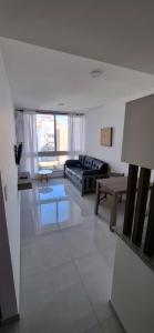 a living room with a couch and a table at ADS DEPARTAMENToS 2 in La Plata +7 photos