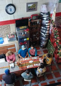 a group of people sitting at a table in a room at Hostel Del Piamonte 2 in Quito