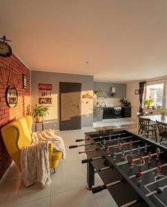 a living room with a large foosball table at Apartamenty koło Szczyrku A&S Spa - basen, jacuzzi, sauna in Szczyrk
