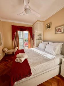 a bedroom with a large bed with towels on it at Casa Neves in Arco da Calheta