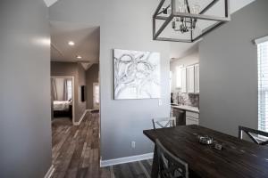 a kitchen and dining room with a table and a painting on the wall at Memphis Charm in Memphis