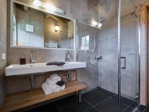 a bathroom with a sink and a shower at BergbiberHAUS XL in Piesendorf +32 photos