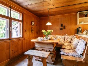 a living room with a couch and a wooden table at Waldhüsle in Dalaas