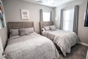 a bedroom with two beds and a window at Memphis Charm in Memphis