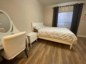 a bedroom with a bed and a vanity and a mirror at Modern 2BD Apartment with 2 Baths in Alhambra in Alhambra
