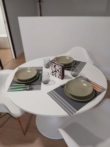 a white table with two plates on top of it at Loft Mamposo in Tacoronte +7 photos