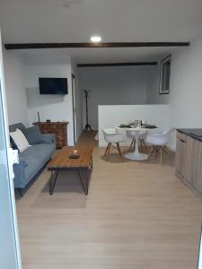 a living room with a couch and a table at Loft Mamposo in Tacoronte