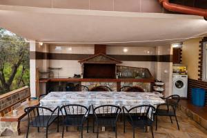a large dining room with a table and chairs at Narcis House in Thessaloniki