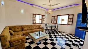 a living room with a couch and a table at Villas calme et sans vis-à-vis proche de la plage Tezdaine in Midoun