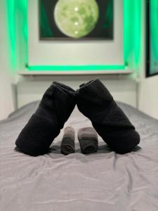 a person wearing black socks on a bed at MoonGreen - EuroAirport - Basel - HighQuality in Saint-Louis