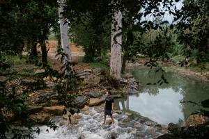 a man standing in the water near a river at Khanom Station 549 in Khanom +38 photos