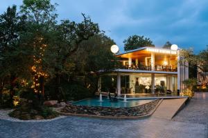 a large house with a swimming pool in front of it at Khanom Station 549 in Khanom