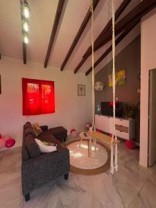 a living room with a couch and a swing at Eden hibiscus in Petit-Canal